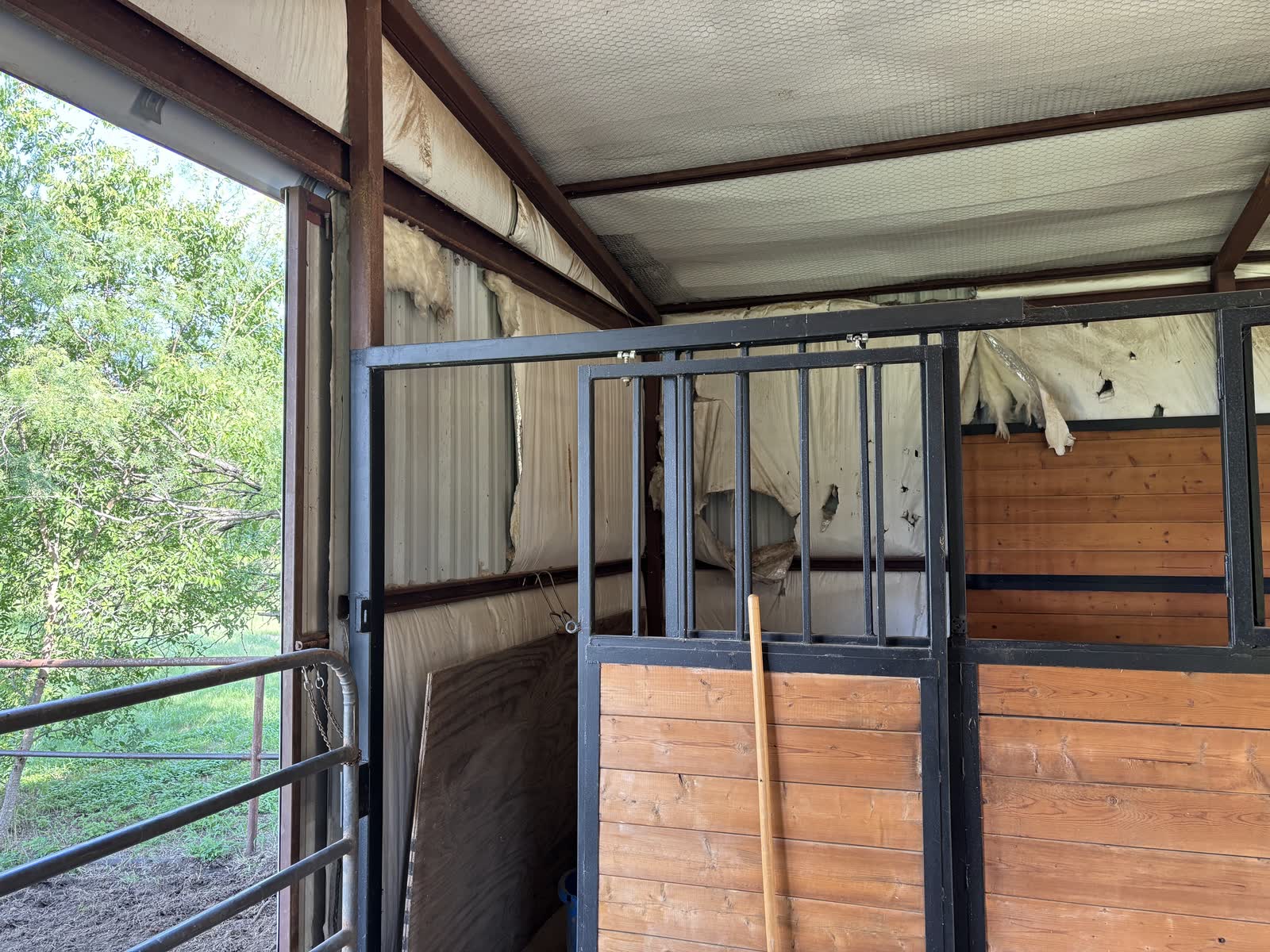One of the original stalls before the remodel, with a barred upper front and wood lower panels